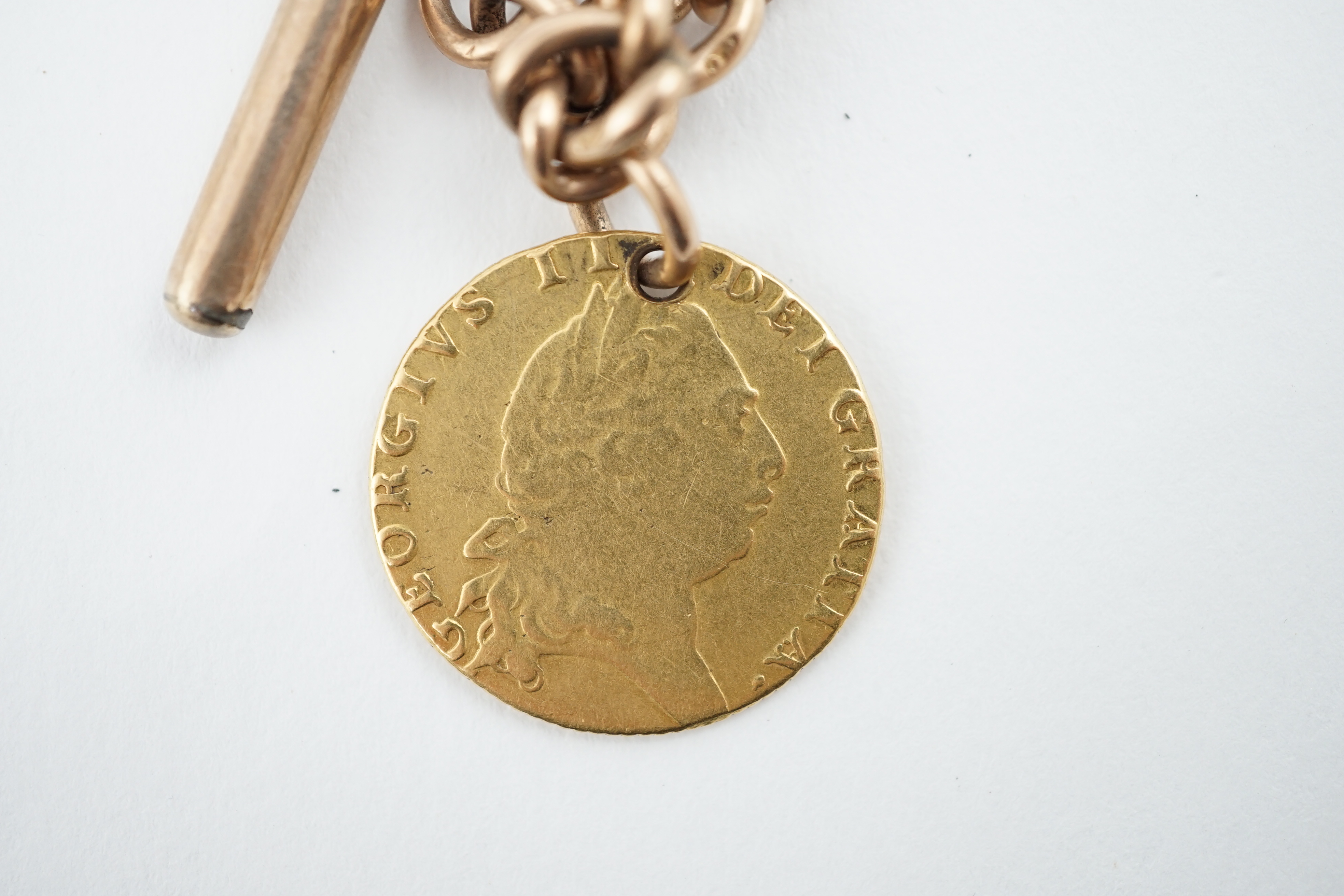 A 9ct gold albert, with gold plated T-bar and hung with a George III 1794 gold spade guinea